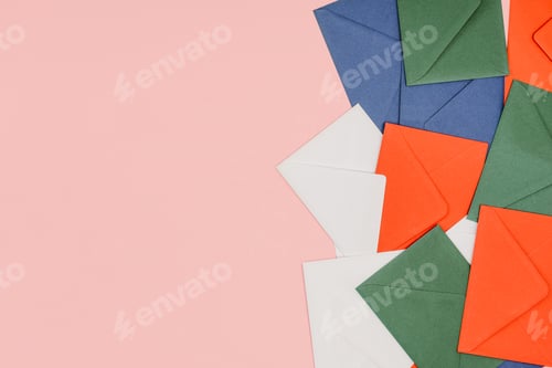 Preview: top view of colorful envelopes isolated on pink background