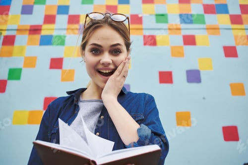 Preview: cheerful woman with notepad in her hands colorful wall on background education