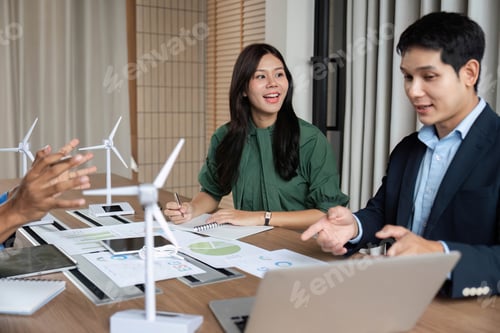 Preview: ESG Strategy Meeting. Professionals discussing renewable energy solutions with wind turbines.