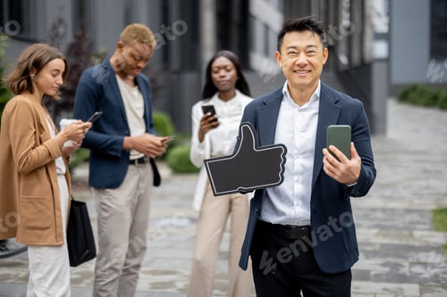 Preview: Man showing thumb up on background of colleagues