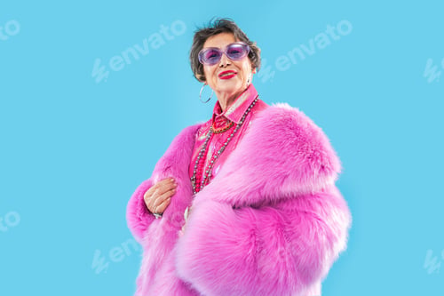 Preview: Happy and funny senior old woman on colorful background