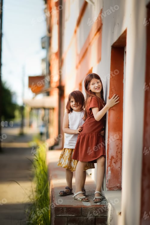 Preview: Summer time, Cute girls sisters in dresses walk around the city,