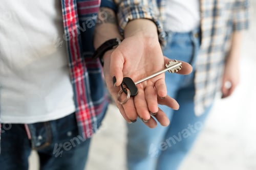 Preview: Couple showing keys to new home.