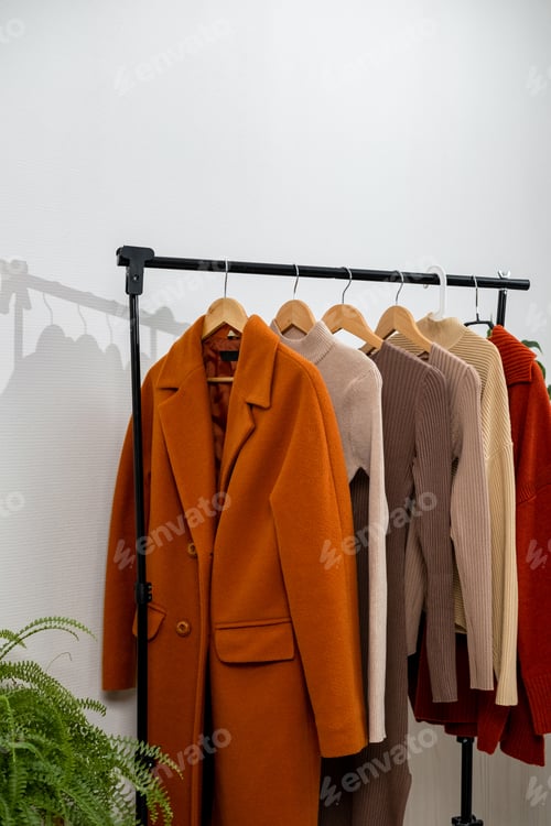 Preview: Rack with stylish women's clothes. Capsule minimal wardrobe for the autumn season.