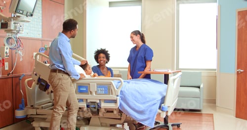 Preview: Female Doctor Or Nurse With Soft Toy Meeting Parents Visiting Daughter In Hospital Bed
