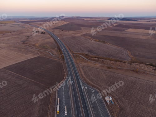 Preview: Aerial view of highway road at sunset in autumn. Top view from drone of road