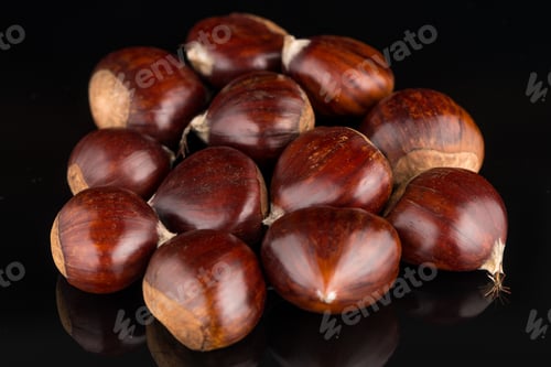 Preview: Chestnuts on a black reflective background