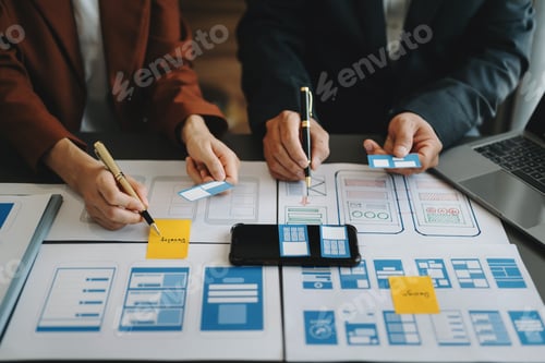 Preview: UX developer and ui designer brainstorming about mobile app interface wireframe design with customer