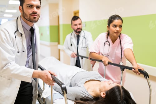 Preview: Doctors And Nurse Pushing Patient On Gurney In Hospital