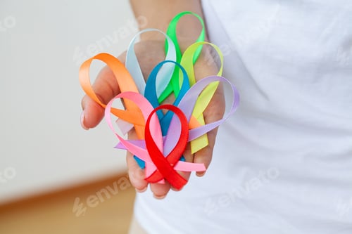 Preview: Female doctor holds colored ribbons symbolize awareness of various diseases
