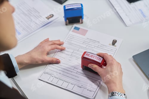 Preview: Woman Reviewing Visa Application and Stamping Rejected at Visa Center