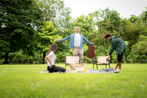 Preview: Happy multi generational Asian family enjoying picnic in the park,
