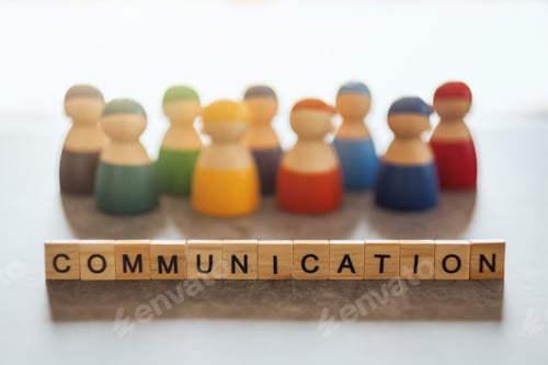 Preview: COMMUNICATION word on wooden blocks with a group of people in the background