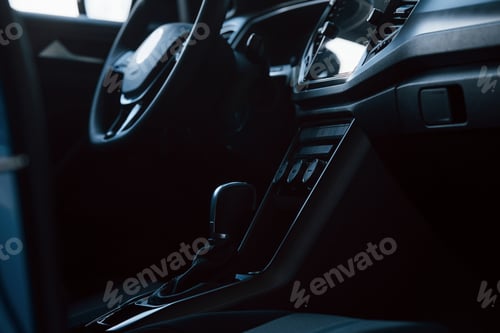 Preview: Front panel of luxury new car in the automobile salon. Black interior