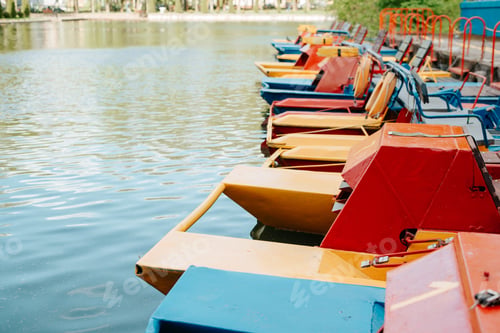 Preview: Boat station of catamarans in park on sunny day. Side view multicolored catamarans on water