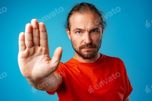 Preview: Bearded man gesturing 'stop' or 'wait a minute"