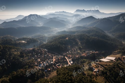 Preview: Traditional tribe village in the valley with Doi Luang Chiang Dao mountain peak and foggy