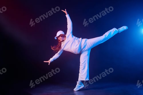 Preview: a girl in light clothes dances on a neon background in smoke, modern dance