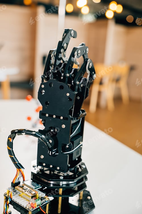 Preview: Cyborg mechanical arm in action as a black real robot hand presses on a table. Illustrating