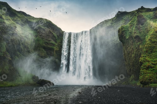 Preview: Dramatic of powerful Skogafoss waterfall with skoga river flowing from cliff on summer in Iceland