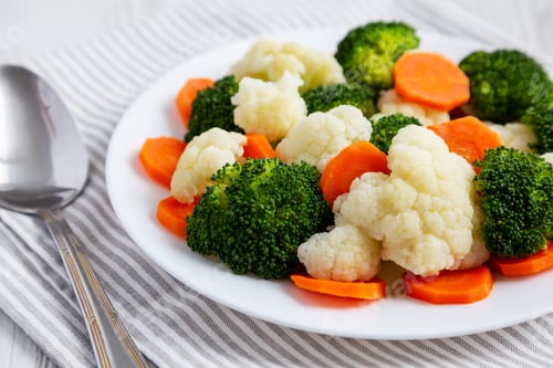 Preview: Mixed Organic Steamed Vegetables (Carrots, Broccoli and Cauliflower) on a Plate