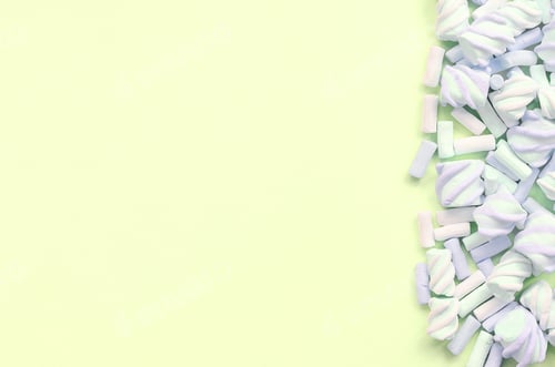 Preview: Colorful marshmallow laid out on lime paper background. pastel creative texture