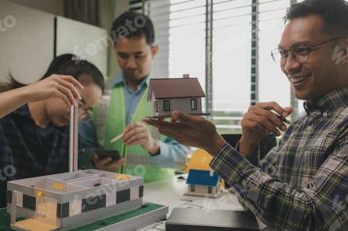 Preview: A team of engineers meets in the office to analyze the design structure to ensure it meets the clien