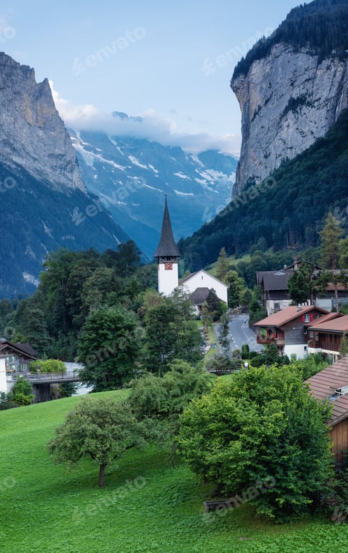 Preview: The village of Lauterbrunner in Switzerland. Vertical panorama. Mountain valley in summer time.