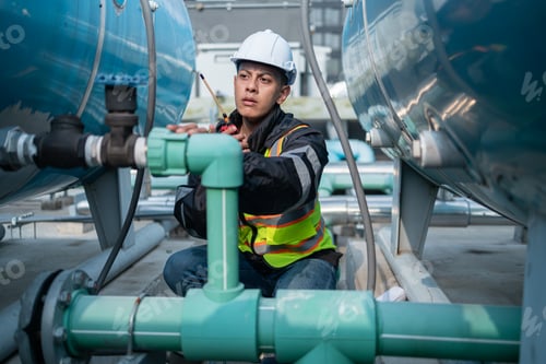 Preview: Industrial Engineer Checking Equipment with Tool