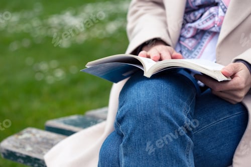 Preview: girl at the park reading a book