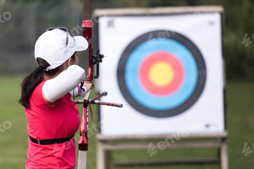 Preview: Female athlete practicing archery in stadium