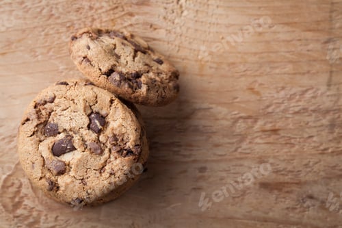 Preview: Cookies with chocolate chips on a wooden table. Top view with copy space