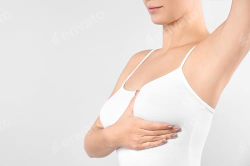 Preview: Woman checking her breast on white background, closeup. Space for text