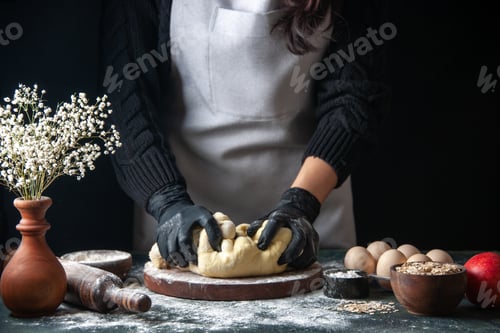 Preview: front view female cook rolling out dough on dark background pastry job raw dough hotcake pie oven