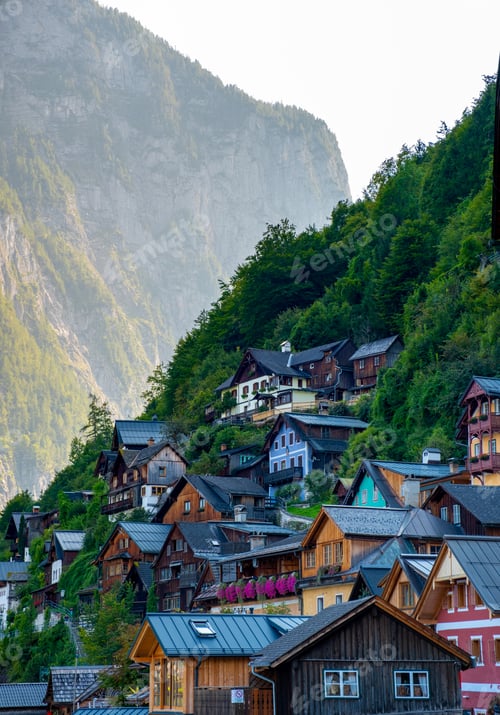 Preview: Charming hillside houses of Hallstatt Austria embraced by majestic mountains at sunset
