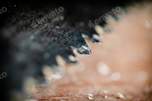 Preview: Hand saw blade on a wooden background.