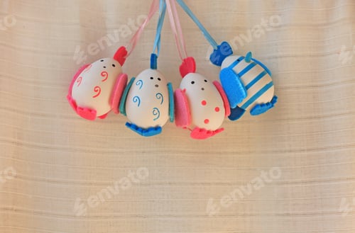 Preview: Easter holiday concept with cute handmade eggs, chicks with felt wings, tail and tuft