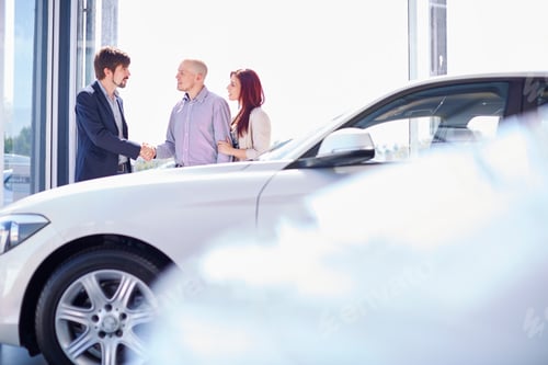 Preview: Car dealer with couple in showroom