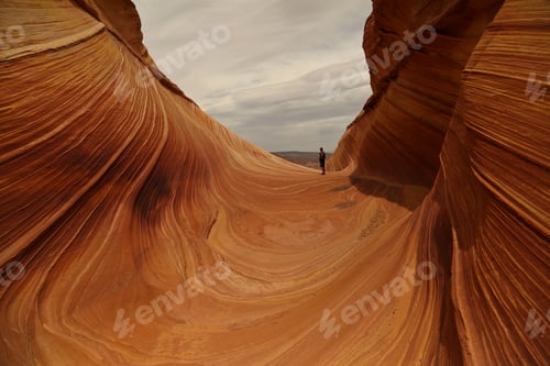 Preview: Beautiful view of a person standing on sandstone rock formation