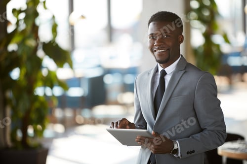 Preview: Purposeful black business manager with tablet