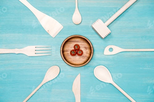 Preview: top view of wooden cooking utensils with cherry tomatoes on plate