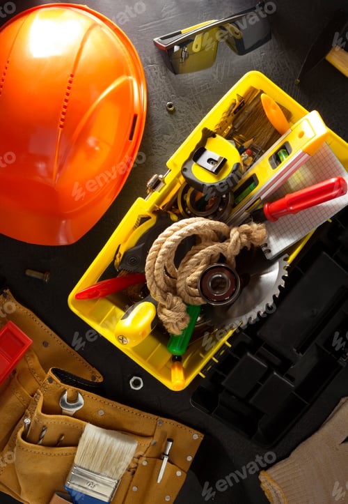 Construction Tools Arranged on a Dark Background