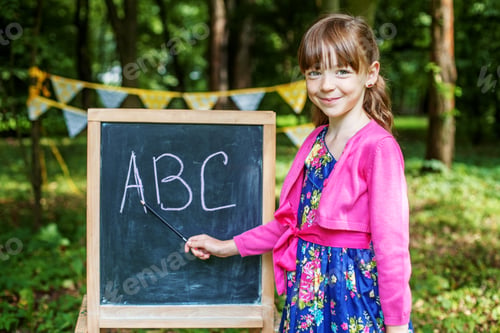 Preview: Student writing letters on a school board. The concept is back t