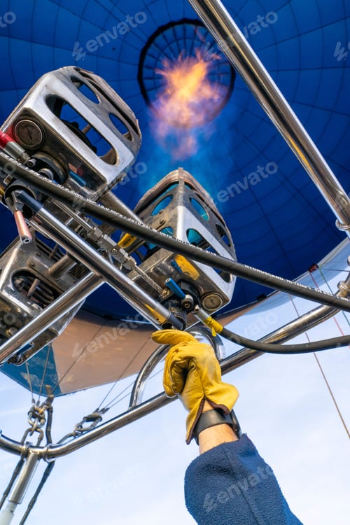 Preview: Hot air balloon pilot giving flame to a balloon