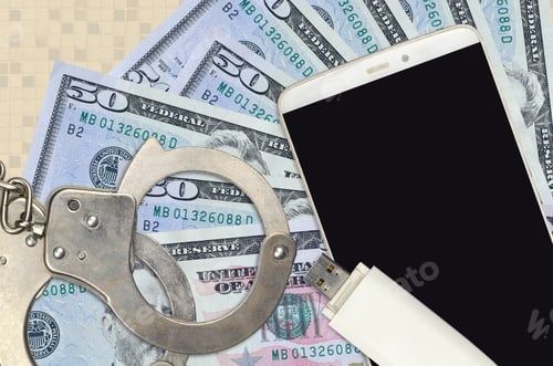 Preview: 50 US dollars bills and smartphone with police handcuffs