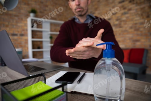 Preview: Mid section of man sanitizing his hands