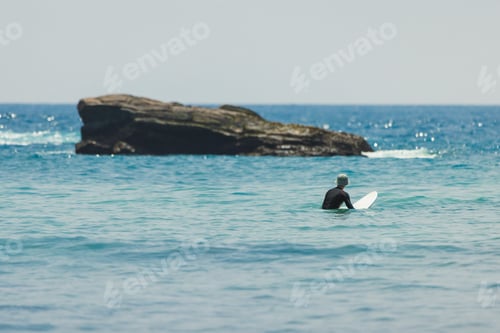Preview: Surfer Waiting for Waves in Calm Waters at Hiriketiya Beach, Sri Lanka