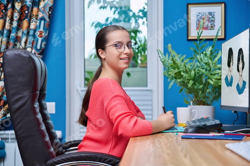 Preview: Young teenage female using graphics tablet to draw on computer
