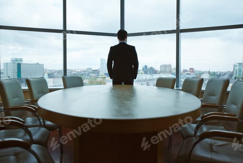 Businessman Contemplates Cityscape from Corporate Office