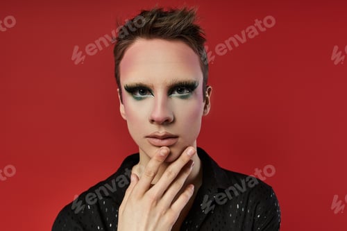 Preview: Dynamic Young Drag Artist Posing Stylishly Against a Bold Red Background